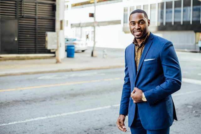 short-haired-black-man-in-blue-suit-in-front-of-empty-street